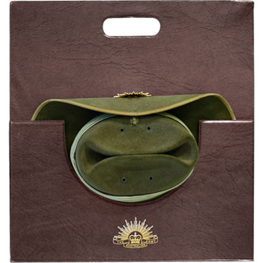 This slouch hat carrier is the perfect travel accessory to ensure your hat stays in perfect condition.  Keep your hat in great shape with this quality dark brown leather-look slouch hat carrier.  Heavy duty card covered with heat sealed PVC. A gold printed Rising Sun completes this item. www.moralepatches.com.au