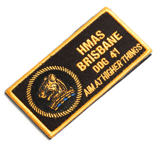 The HMAS Brisbane DPNU Patch is a must-have for all military enthusiasts. This embroidered patch features the iconic HMAS Brisbane design, measuring 100x50mm. With its hook-and-loop backing, it can easily be attached to any garment or accessory. The black and yellow colours add a touch of authenticity to this high-quality patch. Show your support for the HMAS Brisbane with this stylish and durable patch. www.moralepatches.com.au