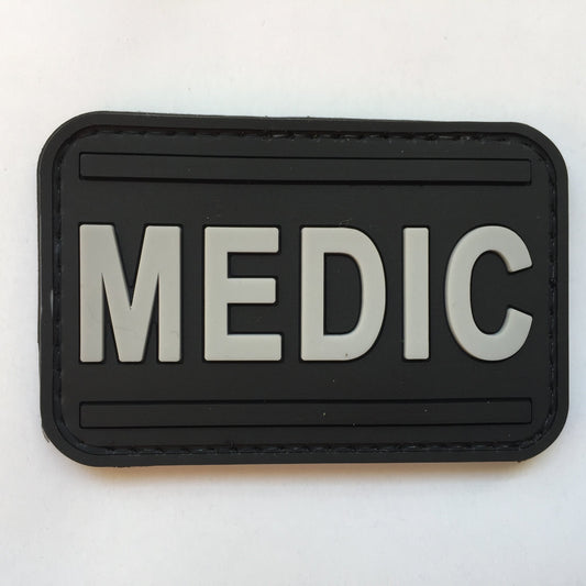 Medic PVC Patch Black and Gray, Velcro backed Badge. Great for attaching to your field gear, jackets, shirts, pants, jeans, hats or even create your own patch board.  Size: 7.5x4cm