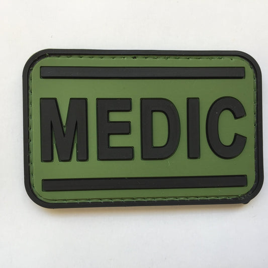 Medic PVC Patch Black and Green, Velcro backed Badge. Great for attaching to your field gear, jackets, shirts, pants, jeans, hats or even create your own patch board.  Size: 7.5x4cm