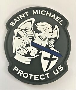 Saint Michael, Protect us PVC Patch, Velcro backed Badge. Great for attaching to your field gear, jackets, shirts, pants, jeans, hats or even create your own patch board.  Size: 7.5x5.5cm