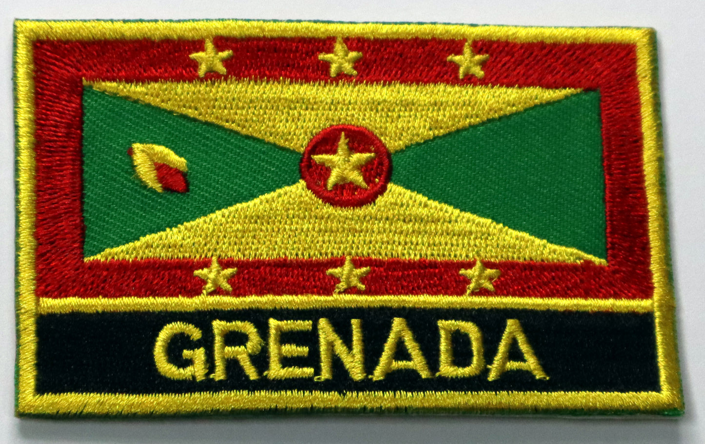 Grenada Flag Iron On Patch. Great for attaching to your jackets, shirts, pants, jeans, hats.  Size: 8x5cm