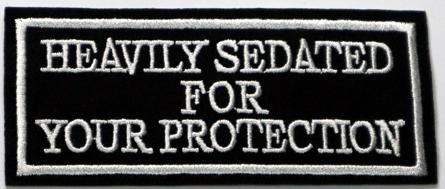 Heavily sedated for your protection Iron On Patch. Great for attaching to your jackets, shirts, pants, jeans, hats.  Size: 9.8x4.2cm